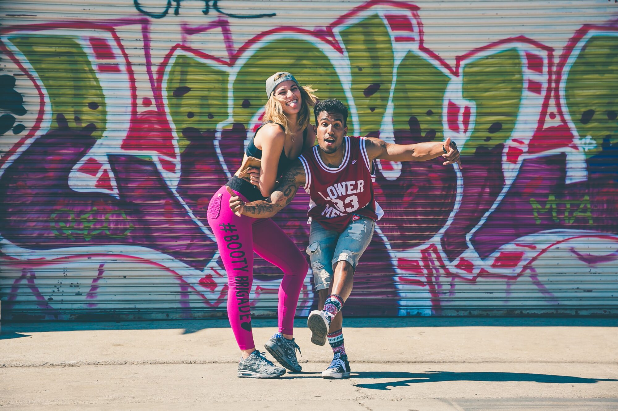 dancers in front of graffiti